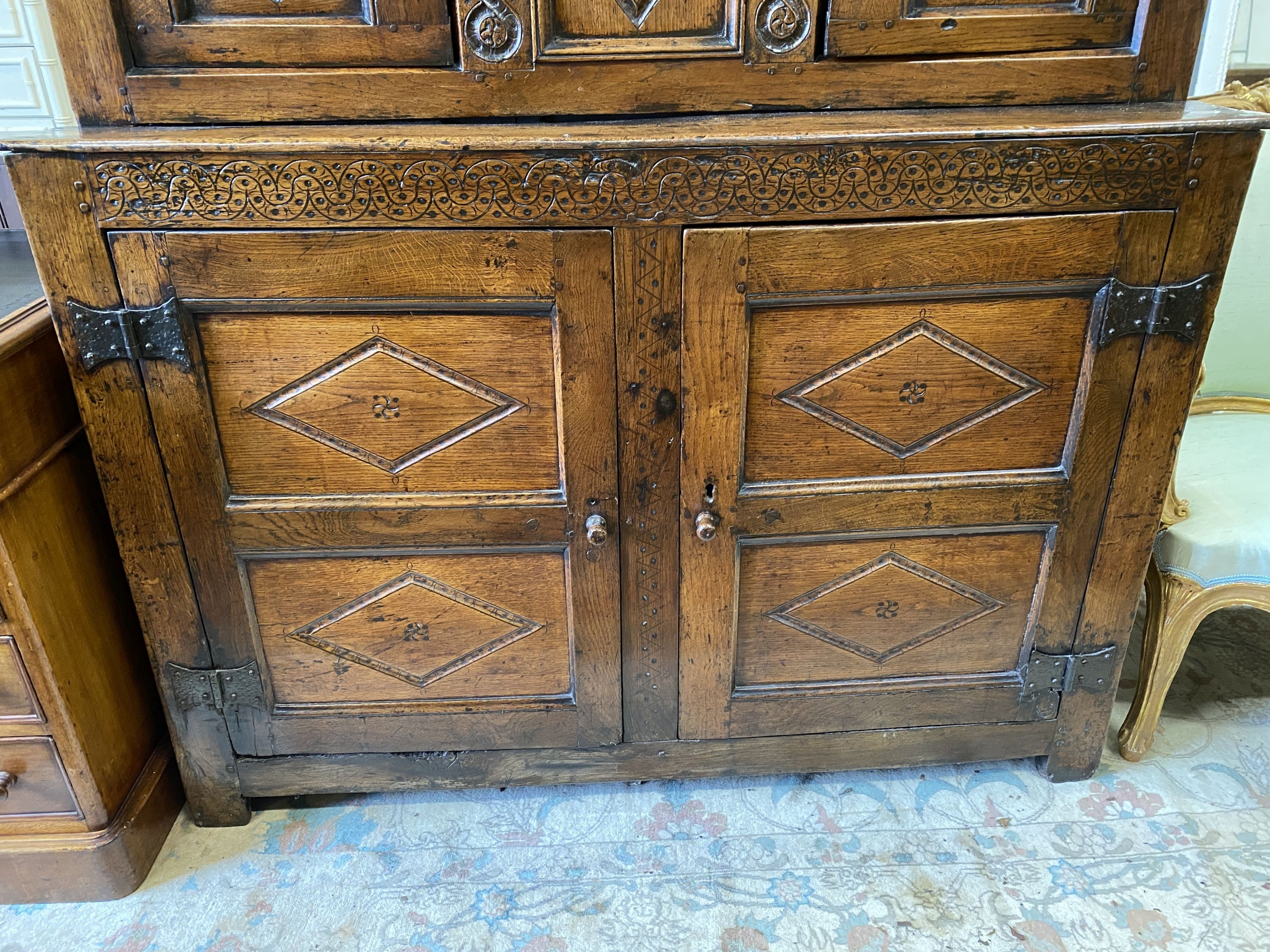 A Charles II oak court cupboard, dated 1673, width 140cm, depth 52cm, height 148cm